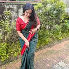 A full-length view of this understated and elegant look. The hair is styled in simple, loose waves, and the makeup is fresh and light, perfect for a daytime family gathering.