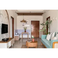 I designed this open-plan living and dining area to be a serene, bohemian-inspired oasis. The layout maximizes space and light, featuring a custom L-shaped dining bench and a mint green sofa for a fresh, inviting feel.