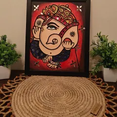 A beautiful Ganesha rendered in the Lippan art style. This piece combines traditional mirror work with vibrant colors to create a modern-traditional fusion.