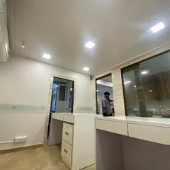 A complete view of the new office space for CA Suneet Rastogi, showcasing the open-plan work area. I used a PVC ceiling and bright lighting to make the space feel larger, while the custom desks provide ample workspace. The glass partition in the background separates the main area from private cabins.