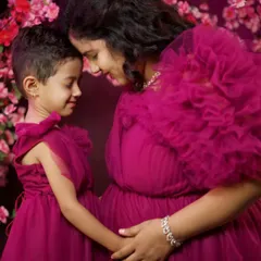 Creating precious memories before the new arrival. We offer matching mother-daughter gowns so your little one can be part of your maternity photoshoot. This is our magenta tulle gown set.