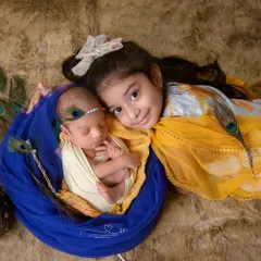A beautiful moment between a big sister and her new baby brother, captured during our Janmashtami theme. Including siblings helps tell a story of family, protection, and the beginning of a lifelong bond.