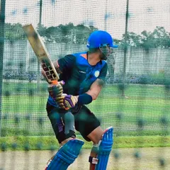 A close-up of a batsman's form during a net session. Notice the high elbow and straight bat, key elements for a classic, controlled drive.