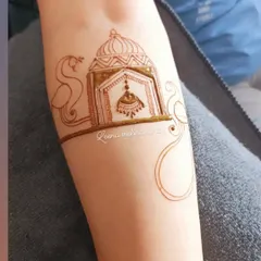 An example of a "heavy startup" design for siders, beginning with the outline of a jharokha (ornate window) and jhumkha. This is how we plan a design on the arm.