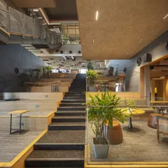 The central staircase at the Primarc office is more than just a connection between floors; it's a hub for spontaneous interaction. The wide, terraced steps double as informal seating and meeting spots, fostering a culture of collaboration.