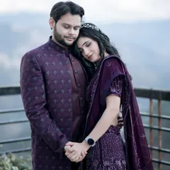 A tender moment captured with the mountains as their witness. She rests her head on his shoulder, a picture of peace and trust. This portrait focuses on their connection, framed by the soft, diffused light of the scenic location.