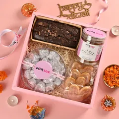 Our 'Shagun' hamper is designed for the joy of gifting. It features a Choco Chunk tea cake, coffee cashew cookies, cashew rocks, and crispy French Hearts.