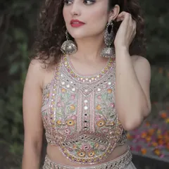 A close-up of the stunning mirror and thread work on the blouse of our grey party lehenga. The intricate detailing makes it a true showstopper.