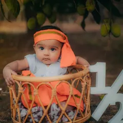 A serious moment from our little mango pie. The rustic basket and half-birthday sign complete this adorable outdoor setup.