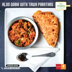 A simple, homestyle favorite: Aloo Gobhi with Tawa Parathas. This dry vegetable dish made with potatoes and cauliflower is lightly spiced and tastes just like it's made at home.