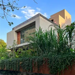 Here, the House of Terraces appears to float on a bed of green. I used varying shades and heights of plants, from cascading vines to tall grasses, to create a lush, layered effect that nurtures the architecture and integrates it with the site.