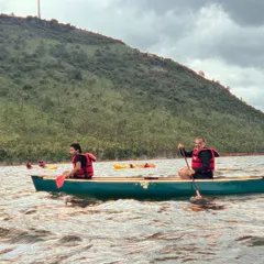 A father and son paddle a canoe together on Vani Vilas Sagar. Canoeing is a fantastic activity for families to connect and learn a new skill in a beautiful setting.