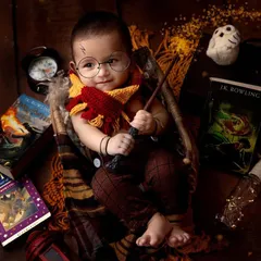 Wingardium Leviosa! This Harry Potter theme is a favorite for so many parents, and look at this little wizard. With the Gryffindor scarf, round glasses, and magic wand, this studio portrait brings a little bit of Hogwarts magic to life.