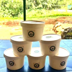 A stack of our branded, reusable food containers. We are committed to finding sustainable solutions for our trips.