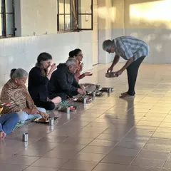 The practice of Karma Yoga, or selfless service. Here, I am serving food to participants during a community meal, an act of love and humility that is central to the yogic path.