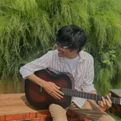 Lost in the music. A candid moment from a photoshoot, just strumming my guitar and enjoying the quiet.