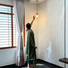 Textured walls: because flat surfaces are for basic feelings. Add a light? Instant depth. A fluted wall panel comes to life with a single, elegant pendant.
