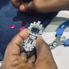 These are the hands that craft perfection. This image captures a moment of intense focus as an artisan works on a complex setting. Every piece of jewellery, whether a simple ring or an intricate necklace, passes through these skilled hands, ensuring the highest quality of craftsmanship.