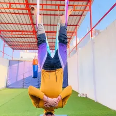Just hanging upside down, smiling. This simple inversion is one of the best things you can do for your mood and your spine. All the blood rushes to your head for a natural energy boost.