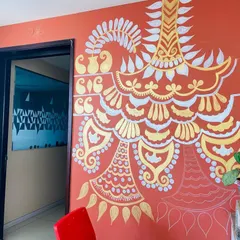 A work-in-progress shot of the 'Ethnic Ether Mural'. You can see how the ivory and gold patterns start to build upon the deep red wall, creating a beautiful contrast.
