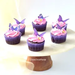 These chocolate mousse cupcakes were for a first birthday party with a fairy theme. Each one is topped with pink frosting and a delicate, edible purple butterfly.