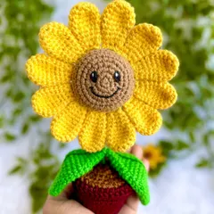 A close-up of the smiling sunflower's face. It’s the little details like the embroidered smile and eyes that give it so much personality.
