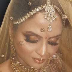 A beautiful portrait of my bride through her golden veil. The soft focus creates a dreamy effect, highlighting her glowing skin and the intricate details of her eye makeup.