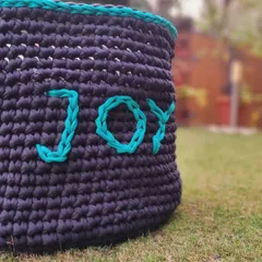 A close-up of the 'Joy' toy basket. Using recycled yarn is important to me, as it helps reduce waste and supports my belief in sustainable crafting.