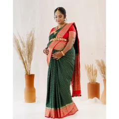 For this traditional maternity shoot, the client wore a beautiful green and red silk saree. I styled her with classic temple jewelry, a neat hair bun with flowers, and makeup that highlighted her features with a bold red bindi, creating a timeless and divine look.