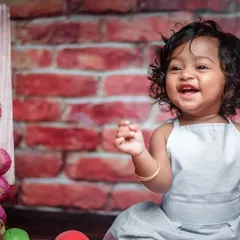 Look at that happy smile. Milestone sessions are all about fun, and my 'Little Chef' theme is a perfect example. We get a little messy with some flour and capture your baby's budding personality in a playful studio setting.