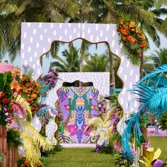 A bold and artistic entrance for a tropical-themed Haldi in Goa. I used layered panels with abstract and animal prints, framed by brightly colored foliage, to create a wild and whimsical jungle vibe right by the beach.
