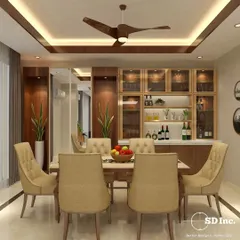 This dining area showcases a beautiful custom-built crockery unit with glass-front cabinets and integrated lighting. The warm wood tones and tufted dining chairs create a welcoming and elegant atmosphere for family meals.