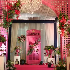 A quirky and fun photo booth idea. I had a classic British telephone box painted pink and adorned with flowers to match the event's vibrant, whimsical theme.