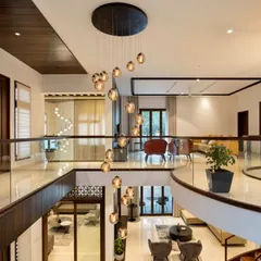 A view from the upper level shows how we use lighting as jewelry for the home. The cascading chandelier becomes a central sculpture, connecting the two floors of this open and airy residence.