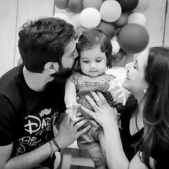 A timeless black and white family portrait from a first birthday photoshoot. This classic style emphasizes the emotional connection and love within the family.