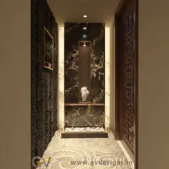 This foyer design uses a dark marble-finish back panel to create a dramatic niche. The space is softened with a textured wall, a simple wooden door with a geometric pattern, and ambient lighting.