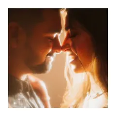 A soft, dreamy close-up using a flare effect to create a warm, golden glow. This technique enhances the romance and intimacy of the moment, making it feel like a memory.