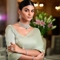 A high-end jewellery campaign featuring a model in a diamond and emerald necklace set. The clean, elegant styling and soft lighting ensure the jewellery is the star of the show.