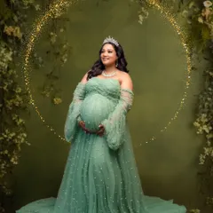 A magical portrait in a pearl-studded green tulle gown, enhanced with a sparkling golden halo effect for a touch of fantasy.