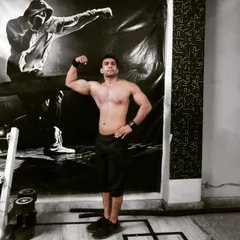 A classic bicep flex after a tough session. My arm workouts are designed for hypertrophy, helping you build size and peak in your biceps and triceps.