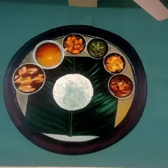This mural shows a traditional Indian food thali served on a banana leaf, as seen from a top-down perspective. The painting's realistic detail and composition make it a compelling feature wall for an eatery specializing in regional cuisine.