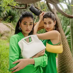 A vibrant outdoor campaign for sustainable fashion brand Sarjaa. This image showcases multiple products and models in a natural setting, emphasizing the brand's eco-friendly ethos with a fresh, modern aesthetic.