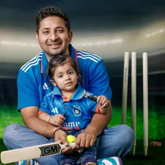 A father and his child, both in team India jerseys, pose with a cricket bat against a stadium backdrop. This entire cricket-themed shoot was created as part of a convenient in-home session.