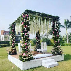 For this daytime garden wedding, I created a beautiful floral mandap. The structure is covered in fresh pink and white roses with hanging tuberose (rajnigandha) and greenery, creating a romantic and natural focal point for the ceremony.