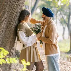 A sweet, romantic moment in the woods. He offers her a bouquet of flowers, a classic gesture of love that I was happy to capture for their love story session.
