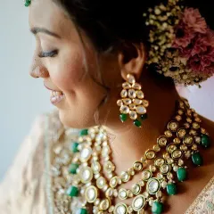 A bridal look is all in the details. Here, I focused on creating a flawless, dewy base to let her natural beauty shine, complemented by soft eye makeup and a floral bun. This close-up captures the timeless elegance perfect for a wedding day.