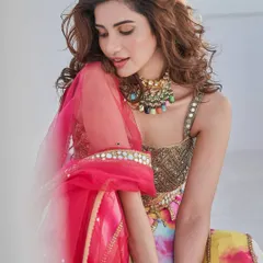 For a vibrant sangeet or mehendi, a pop of color can be stunning. Here, I created a soft glam look with a flawless base that complements the bride's colorful lehenga. The makeup is designed to be bright and joyful while still looking polished and elegant.