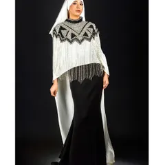 A powerful, direct pose that showcases the full impact of this modern, modest ensemble. The strong contrast between the black skirt and the white, embellished top creates a striking graphic quality.