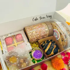 Unboxing the 'Khushiyon Ki Diwali' Box. This hamper is a delightful mix of sweet and savory, featuring a Marbled Biscoff Cube Cake, Jowar Onion Lavash Sticks, Oreo Mini Cookies, Hazelnut Caramel Chocolates, and Lemon Coconut Foxnut Laddoos.