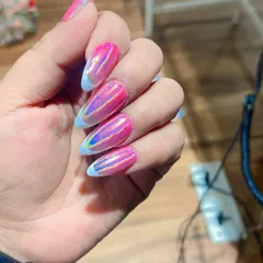 A bold and trendy look featuring a vibrant pink and iridescent chrome effect. The design is finished with a light blue French tip, adding a unique and colorful twist to the holographic style.